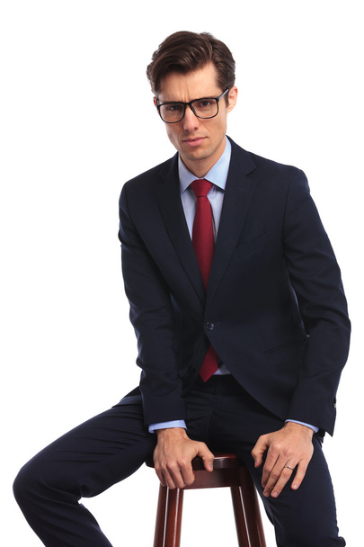 relaxed young business man wearing glasses is sitting - Фото, зображення