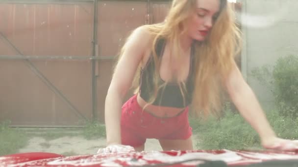 Schlanke Frau wäscht rotes Auto - Filmmaterial, Video