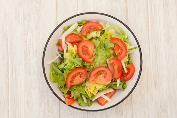 Salad bowl on a white wooden background - Фото, зображення