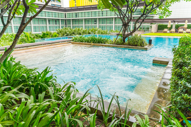 Beautiful Swimming pool in hotel pool resort . - Foto, afbeelding