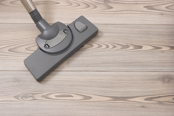 Brush of the vacuum cleaner on a wooden floor. - Photo, Image