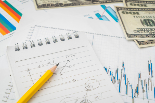 Financial charts on the table with dollars banknotes . - 写真・画像