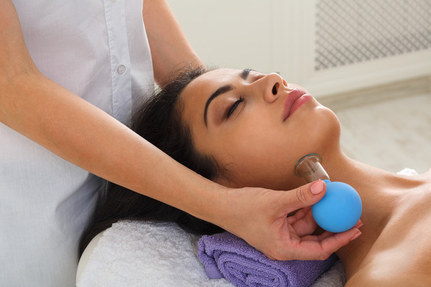 Woman has vacuum massage in ayurveda spa wellness center - Photo, Image