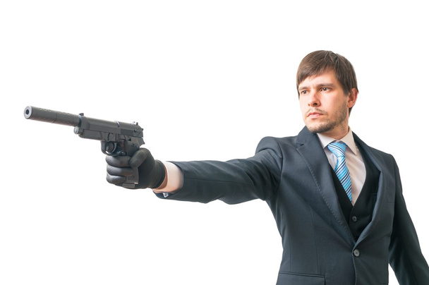 Geheimagent zielt mit Pistole mit Schalldämpfer. isoliert auf weißem Hintergrund. - Foto, Bild
