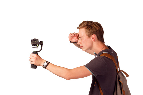 Videographer holds mobile camera on gimbal.  - 写真・画像