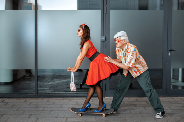 Old man pushes a woman. - Valokuva, kuva