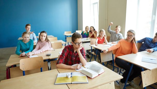 classmates laughing at student boy in school - Photo, image