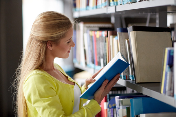 high school student girl reading book at library - Photo, Image