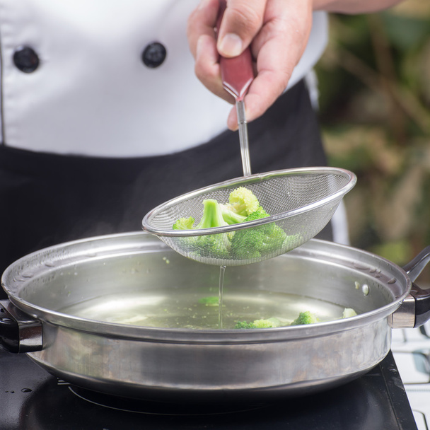 Chef scald broccoli with hot water - Foto, imagen