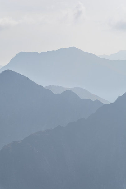 SilhouetteSilhouette of blue mountains in the fog. Seamless background.  - Fotografie, Obrázek