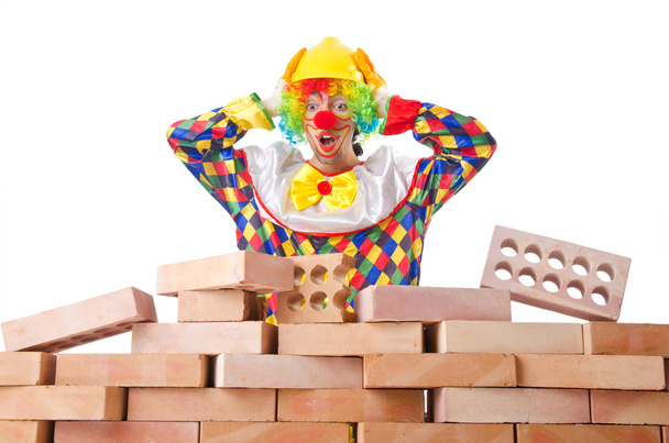 Bad construction concept with clown laying bricks - Photo, Image
