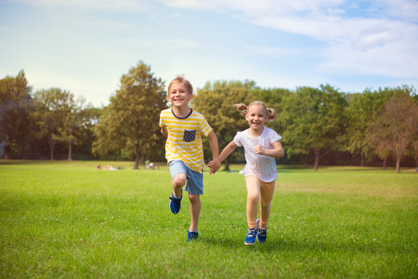 Happy children running in park - Photo, image