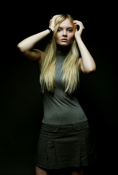 Portrait of beautiful young blonde girl in black dress. - Foto, immagini