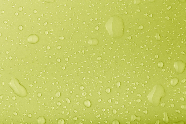 Drops of water on a color background. Toned - Photo, Image