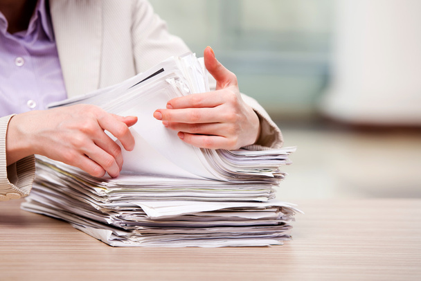 Businesswoman working with stack of papers - Photo, Image