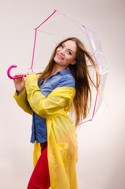 Woman wearing waterproof coat under umbrella - Fotó, kép