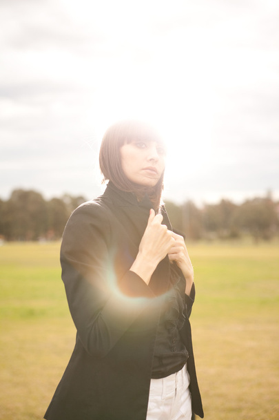 młody kaukaski kobieta w parku z słońce świeci - Zdjęcie, obraz