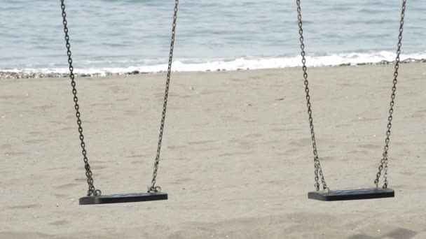 Detail von zwei leeren Sitzen Schaukeln in einem Strand - Filmmaterial, Video