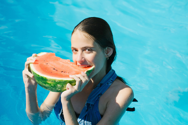woman with watermelon in swimming pool - Zdjęcie, obraz
