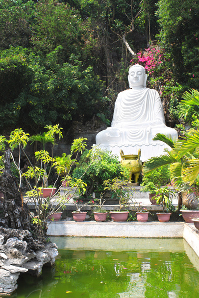 Statue of Buddha near to Pagoda on the marble mountain Da Nang,  - Fotoğraf, Görsel