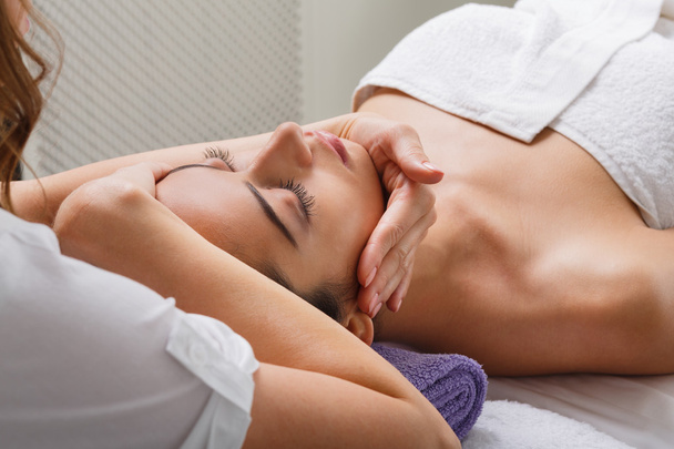 Woman beautician doctor make head massage in spa wellness center - Фото, зображення