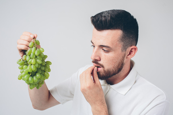 man holding grape, close up. concept. isolated on white - Foto, Bild