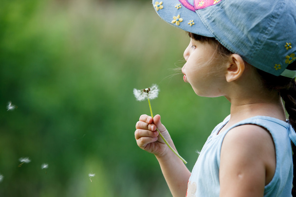 girl blowing on a dandelion - Photo, Image