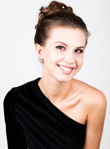 close-up fashion photo of young lady in elegant black dress, playful woman smiling - Photo, Image