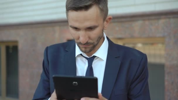 Angry businessman wants to spoil tablet but stops. 4K - Záběry, video