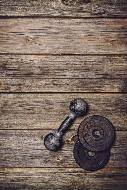 Fitness workout background. Dumbbells on wooden floor - Foto, Imagen