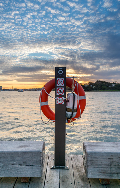 Life Preserver on pole with sunset in background - Photo, Image