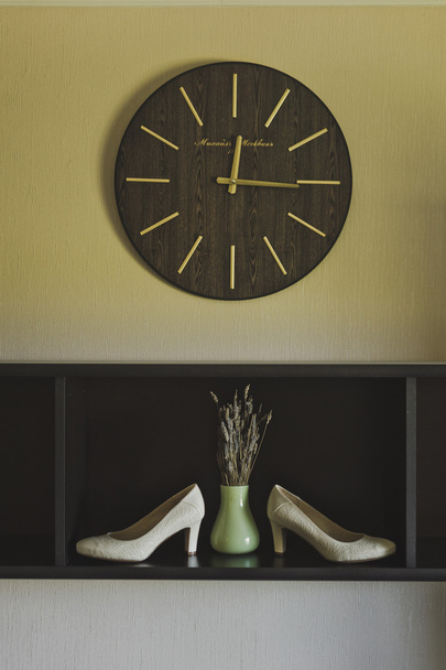 Still life with a clock vase and shoes 6535. - Photo, image