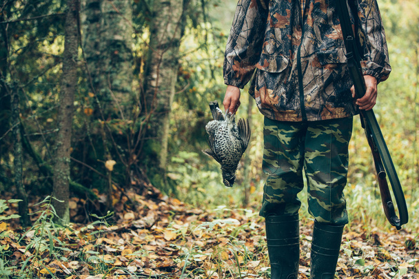 Male hunter holding grouse - Foto, immagini