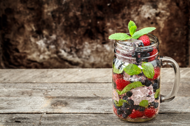Detox drink with fresh berries in glass jars - Fotoğraf, Görsel
