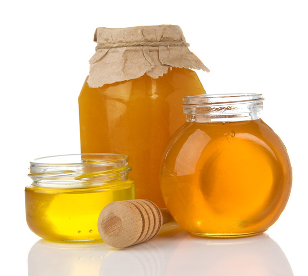 Glass pot full of honey and stick - Foto, Imagem