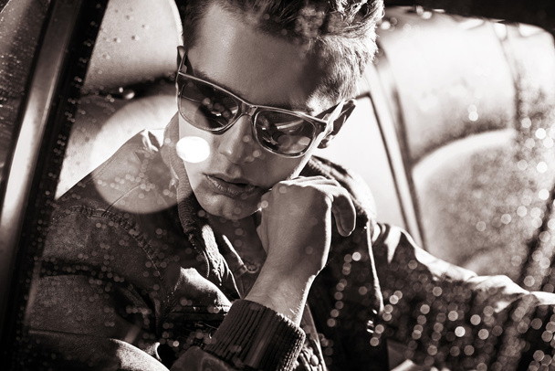 Black&white portrait of a handsome man sitting in the car - Φωτογραφία, εικόνα