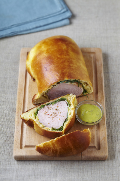 Roast veal in tarragon and brioche on wooden cutting board - Photo, Image