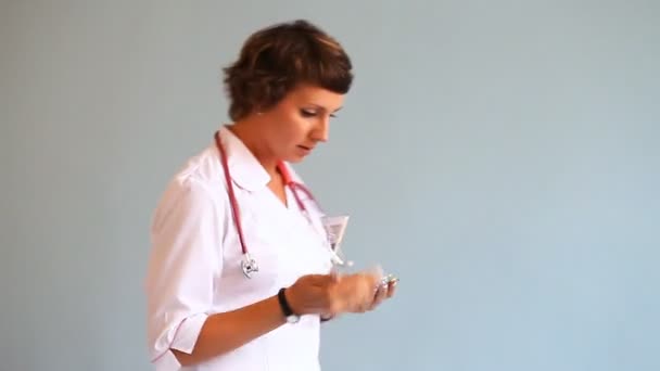 Young woman doctor looking emotionally necessary medicines - Felvétel, videó