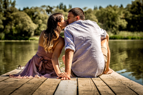 beautiful young couple on the pier near the river - Photo, Image