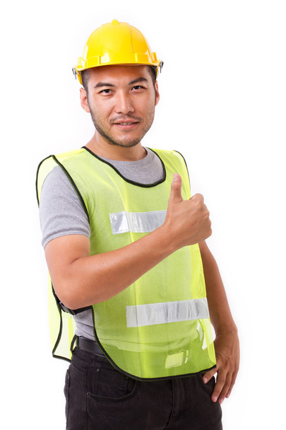 白い背景のジェスチャーを親指を示す建設労働者 - 写真・画像