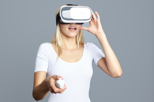 young woman looking through some VR glasses - Foto, imagen