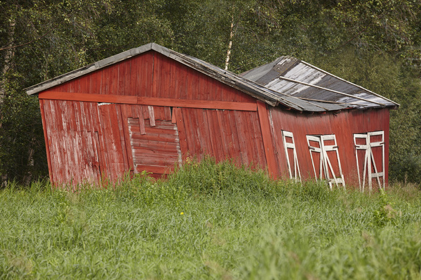 Norway. Red wooden rustic abandoned and curved farm house countr - Photo, Image