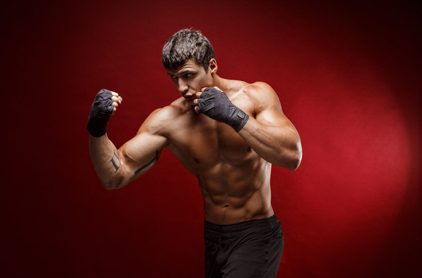 Handsome topless sportsman practicing punches - Photo, image