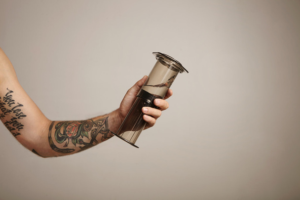 Arm holding an aeropress with clean water - Foto, immagini