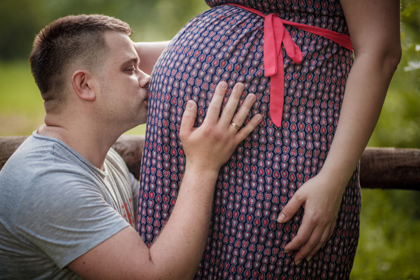 Man is kissing pregnancy belly of his wife - Fotoğraf, Görsel
