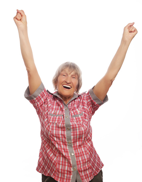 cheerful senior woman gesturing victory over a white background - Photo, image