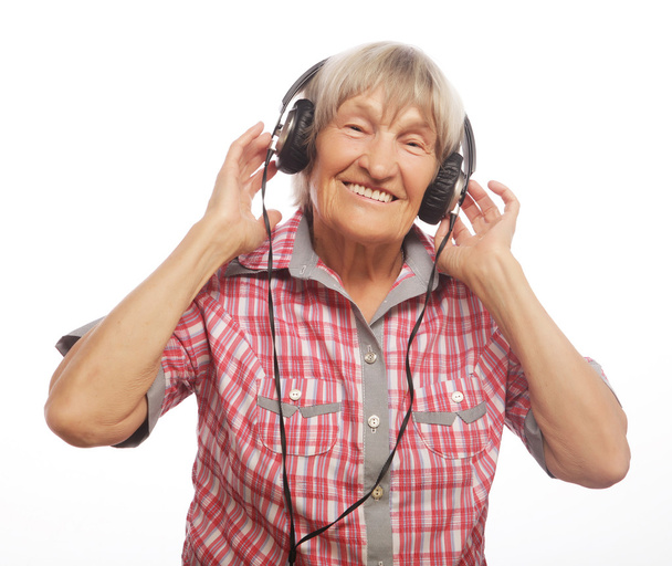 Funny old lady listening music - Фото, изображение