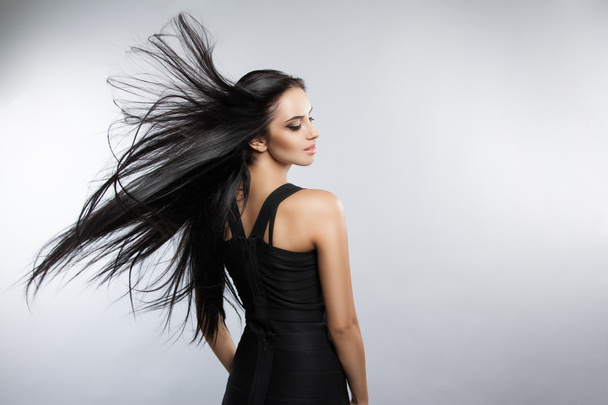 Beautiful girl model with developing the wind hair. - Fotó, kép