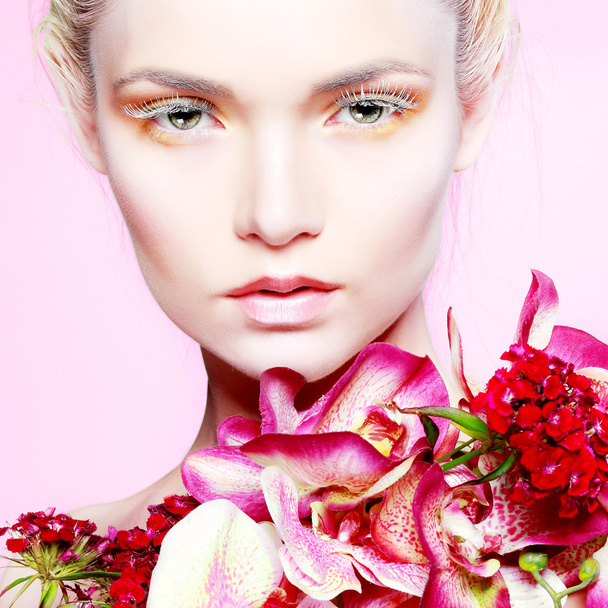 Beautiful  girl with varicoloured flowers - Valokuva, kuva