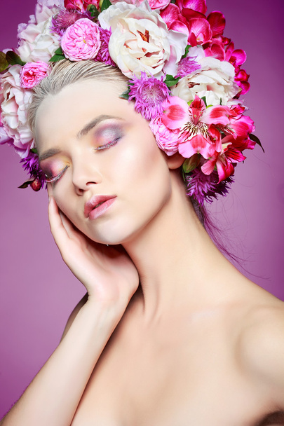 Beautiful  girl with varicoloured flowers - Фото, изображение